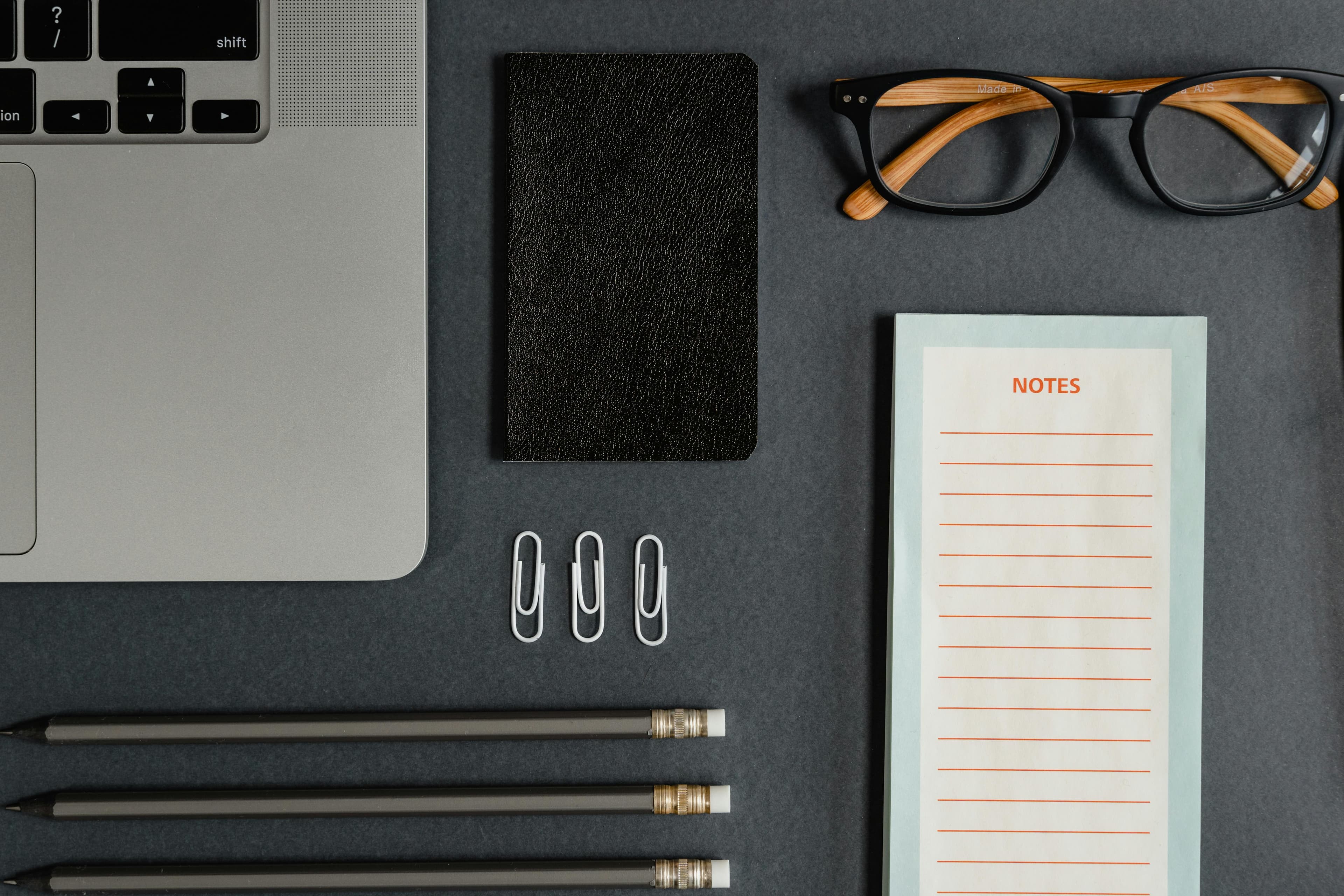 Focused desk workspace with laptop and warm lighting